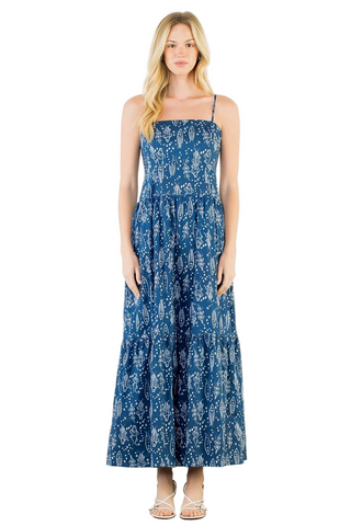 Woman wearing a blue floral dress against a white background