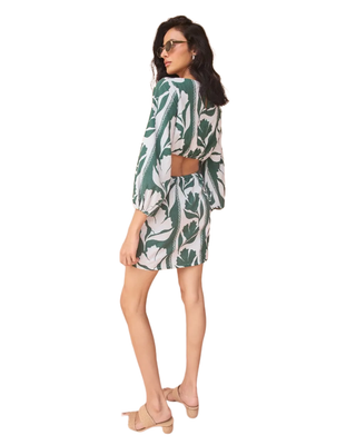 Woman wearing a green and white patterned outfit on a white background