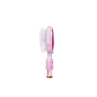 Pink and white hairbrush on a white background