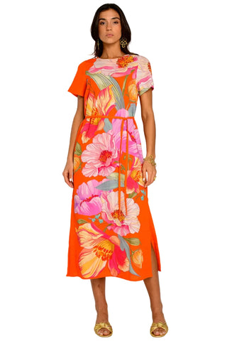 Woman wearing a colorful floral dress on a white background