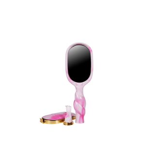 Pink handheld mirror with a black reflective surface on a white background