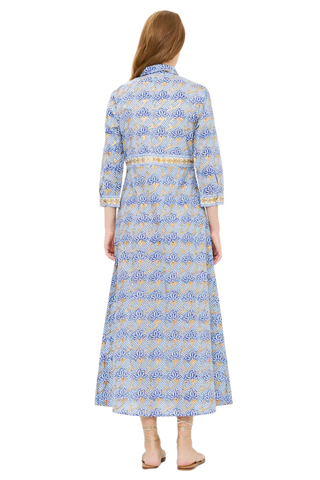 Woman wearing a long, light blue dress with a subtle pattern on a white background