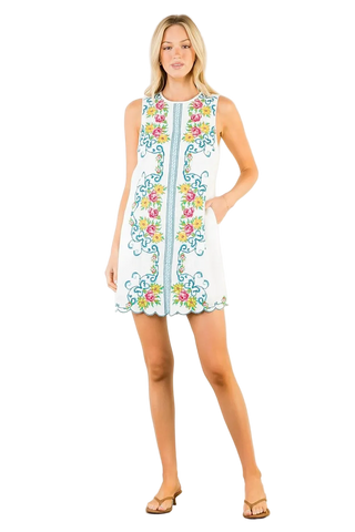 Woman wearing a floral embroidered dress on a white background