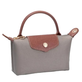 Gray handbag with brown accents on a light surface