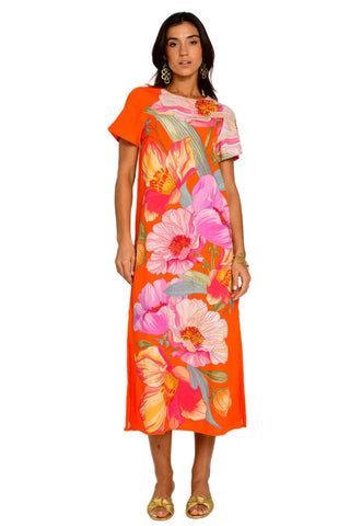 Woman wearing a colorful floral dress on a white background