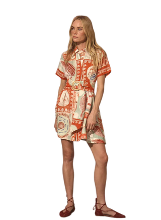 Woman wearing a patterned dress on a white background