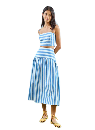 Woman wearing a blue and white striped outfit on a white background
