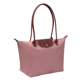 A pink nylon tote bag with dark brown leather handles and a matching brown flap closure, shown on a plain white background.