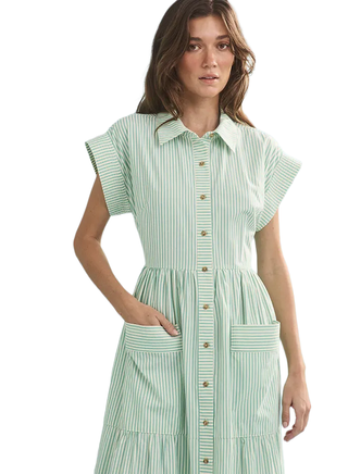 Woman wearing a green and white striped dress on a white background