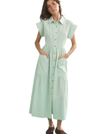 Woman wearing a green and white striped dress on a white background