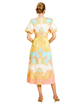 Woman wearing a colorful floral dress on a white background