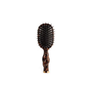Hairbrush with tortoiseshell handle on a white background