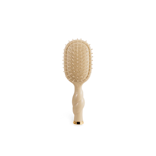 Beige paddle hairbrush on a white background